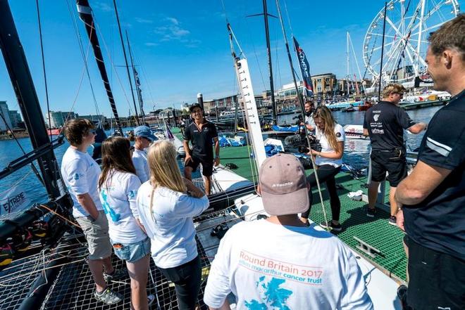 Team Oman Sail show the EMCT crew around their GC32 at the Extreme Sailing Series © Ellen MacArthur Cancer Trust